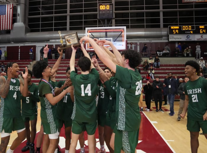 The Irish celebrate their 12th section boys basketball crown. Photo: Darren Yamashita